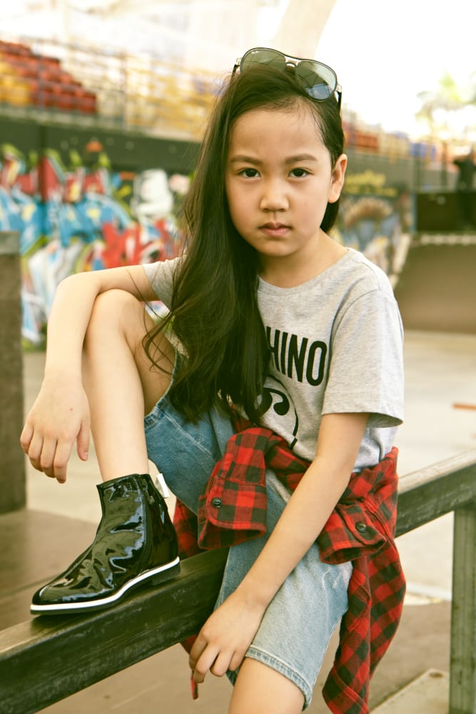 Gabryelle Tang: Shirt, Moschino Kids. Flanner shirt (worn around waist), Zara Kids. Denim shorts, Armani Junior, Patent boots, Baby Dior, Sunglasses, Ray-Ban.