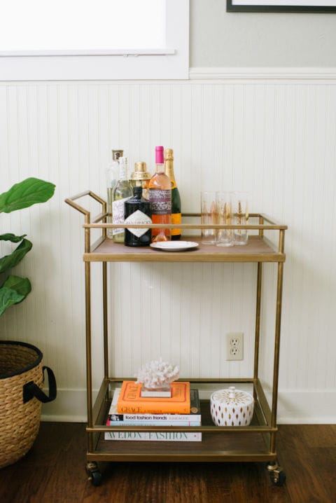 If an overly-styled look isn't for you, here's an idea: Taylor Sterling of Glitter Guide masterfully created this simplistic vignette by limiting the liquor bottles to one corner and using the rest of the cart to show off beautiful books and knick knacks. Brilliant. Photography: Delbarr Moradi