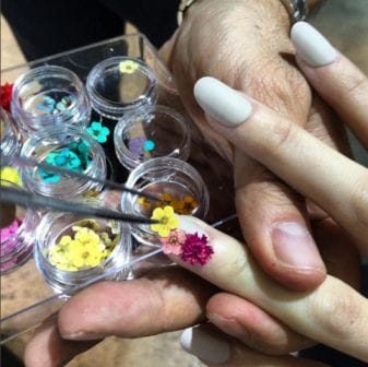 Sacripante applies a mini bouquet to a single nail at Antonio Marras Autumn/Winter’16 