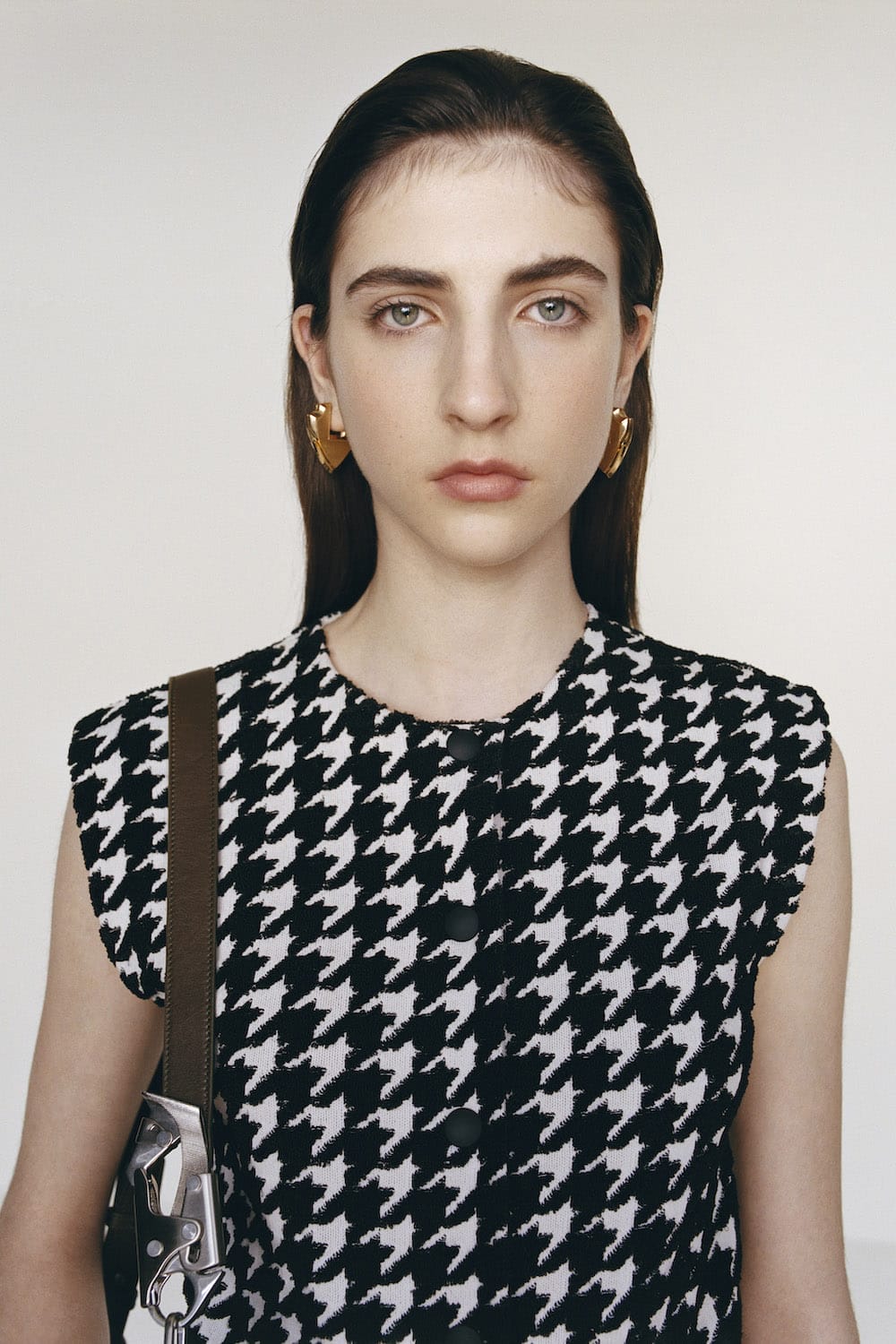 Model with houndstooth check and knight bag for Burberry Spring 2024.