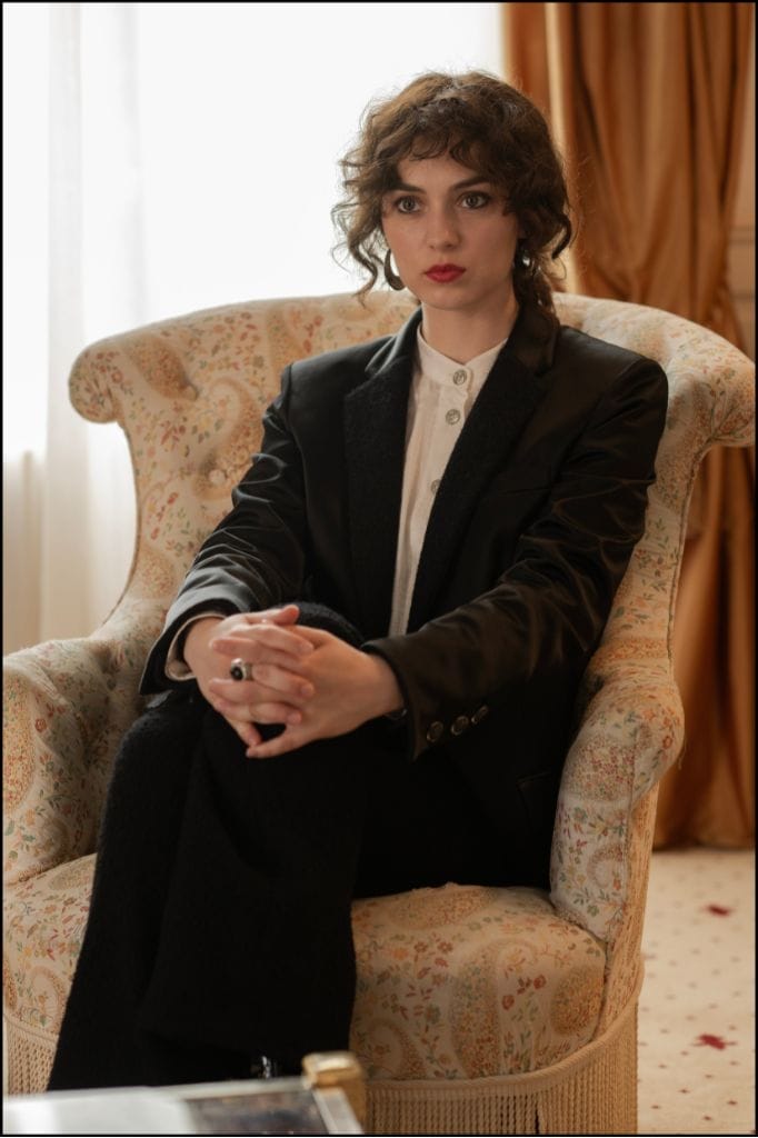 In "Maria", Vartolomei is wearing a trouser suit and boots from the Chanel Fall-Winter 2023/24 Ready-to-Wear collection.