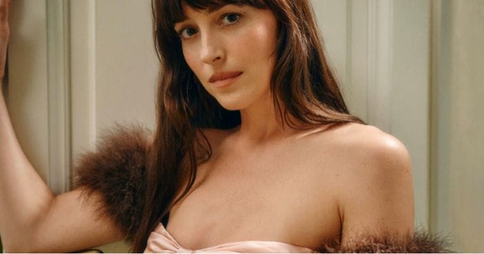 Hollywood actress Dakota Johnson wears a dress with fur sleeves and a pink bow across the chest