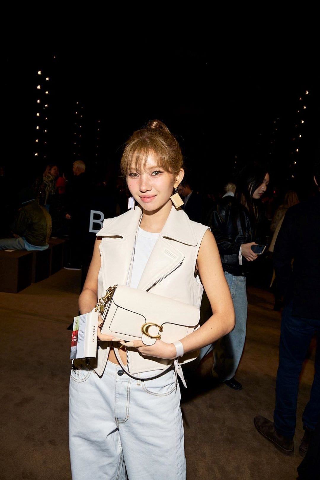 Soyeon from (G)I-DLE poses in a white outfit at Coach's NYFW Fall 2026 show